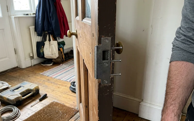 Reinforced strike plate fitted into solid timber